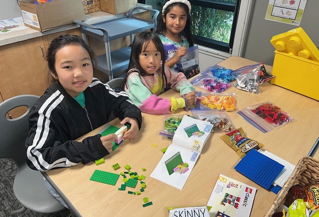 Students building a Lego house with Dr. Carter at the Lego Party! 
