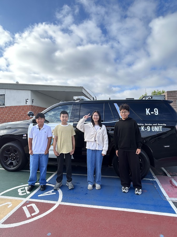 6th Graders Posing with a Police Cruiser on Career Day!