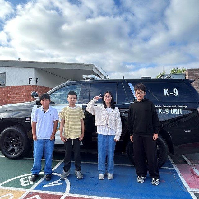6th Graders Posing with a Police Cruiser on Career Day!